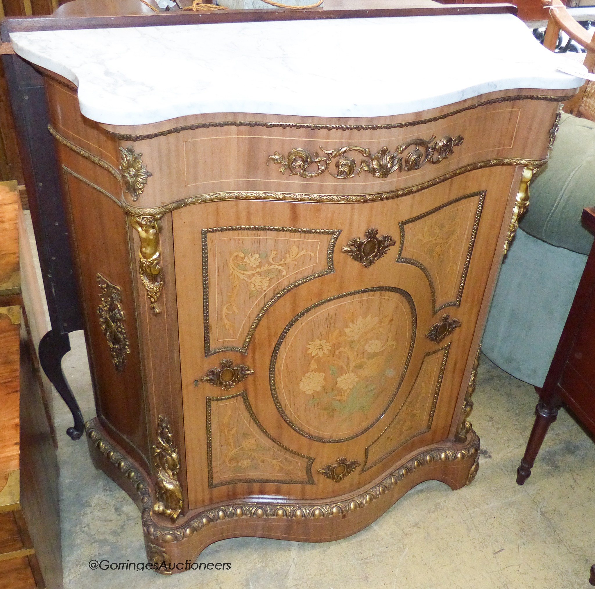 A Louis XV style marquetry inlaid, gilt metal mounted serpentine pier cabinet with white marble top. W-99, D-43, H-103cm.